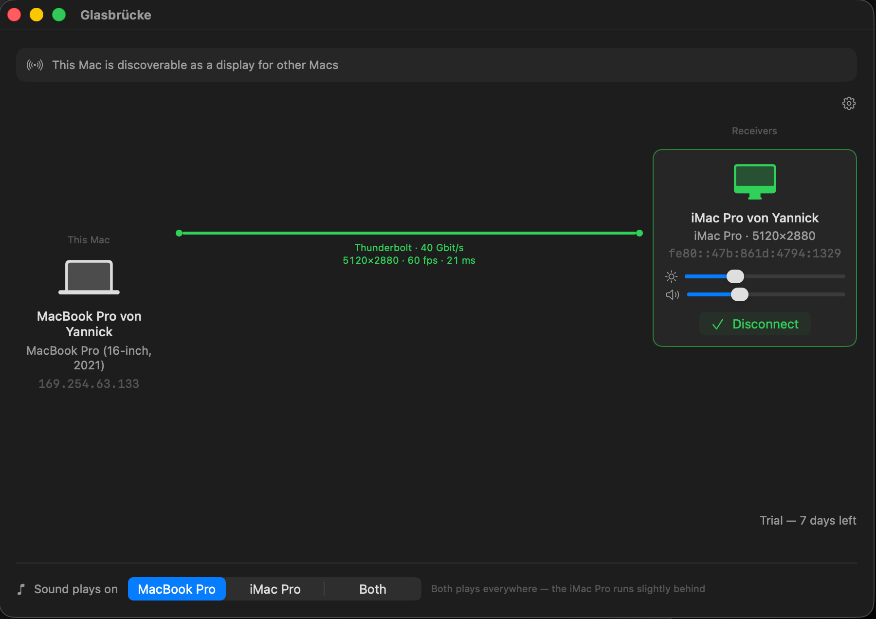 The DisplayBridge window during a live session: a MacBook Pro connected to an iMac Pro over Thunderbolt at 40 Gbit/s, streaming 5120 × 2880 at 60 frames per second with 21 ms of delay, with brightness and volume sliders for the second Mac and a control for where sound plays.
